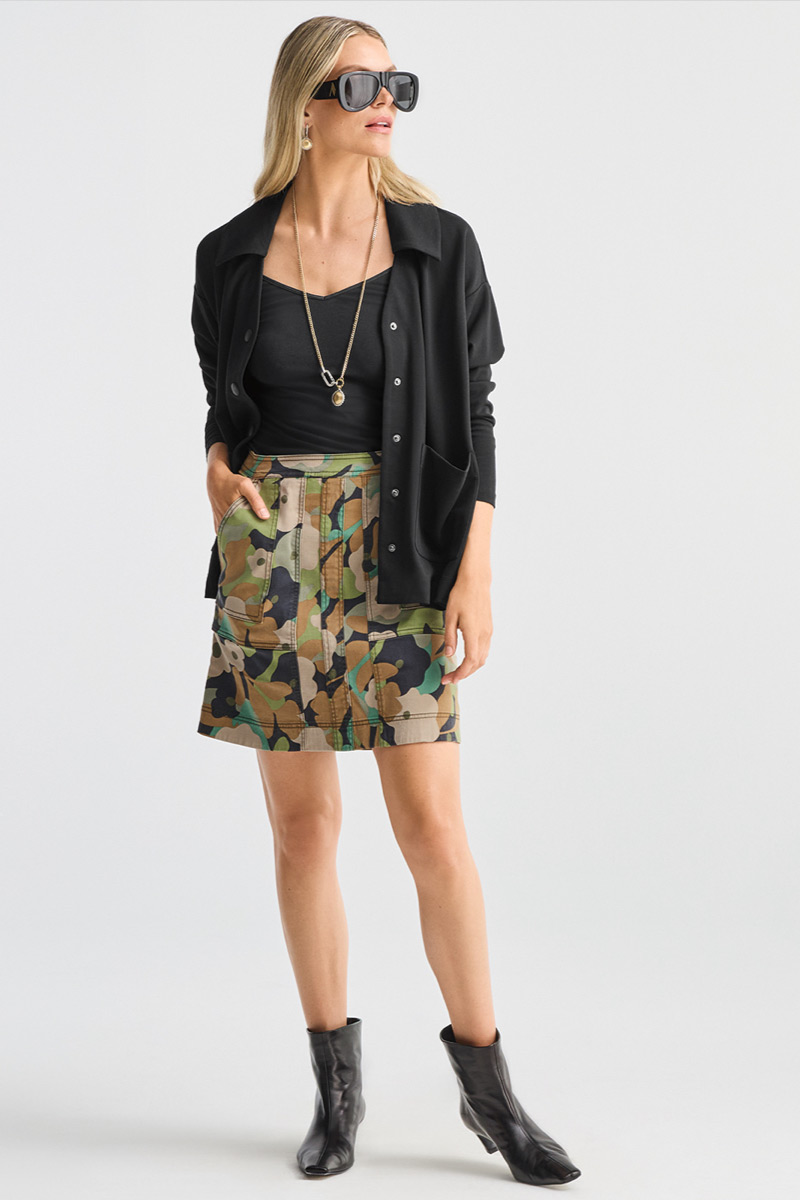 Model wearing Timepiece Necklace in Silver and Gold, Timepiece Earrings in Silver and Gold, Zipline Skirt in Camo, Elemental Topper in Black, V-Neck Cami