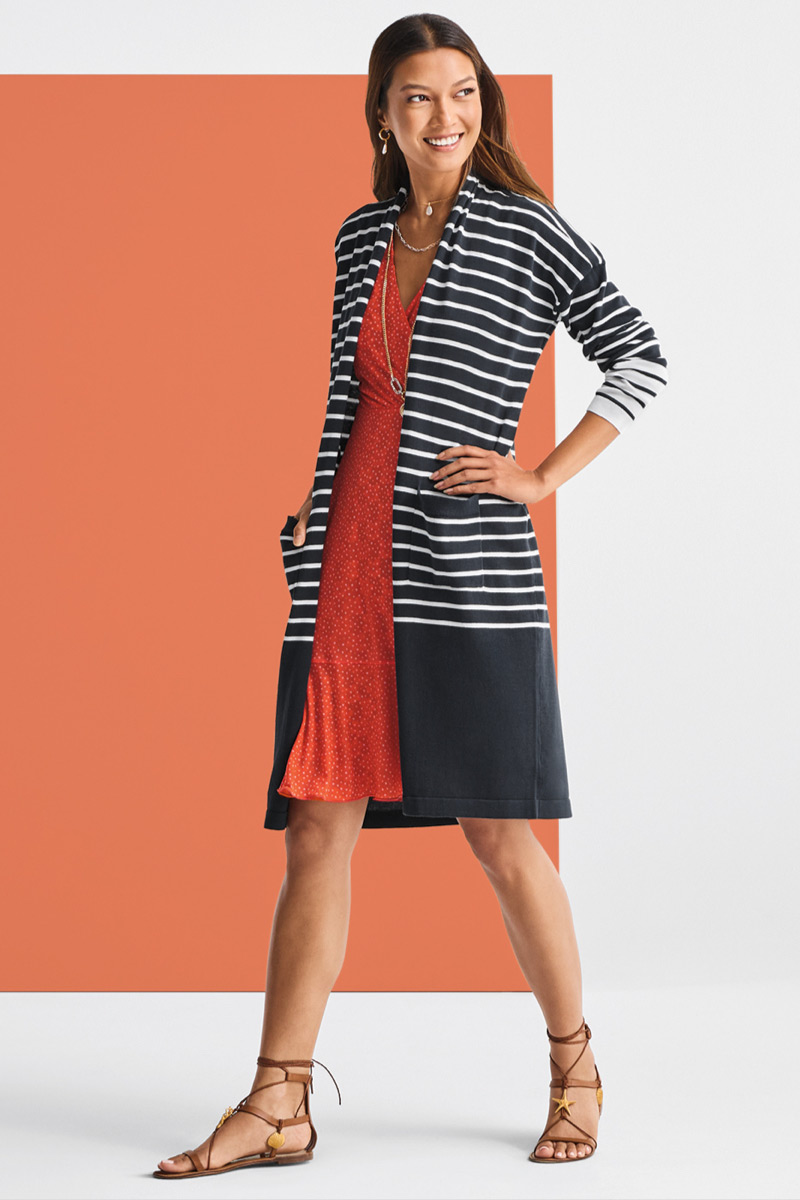 Model wearing Lagoon Necklace in Gold, Lagoon Earrings in Gold, Timepiece Necklace in Silver and Gold, Boathouse Cardigan in Classic Navy and White Stripe, Flip Dress in Dotted Bouquet