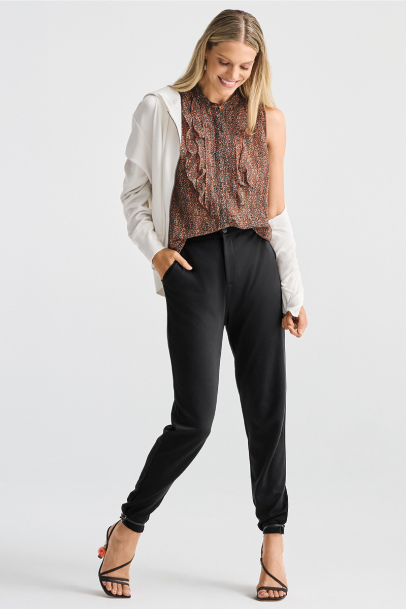 Model wearing Lagoon Earrings in Gold, Tux ruffle top in fouldard print, Debut zipup in white, Pogger in Black