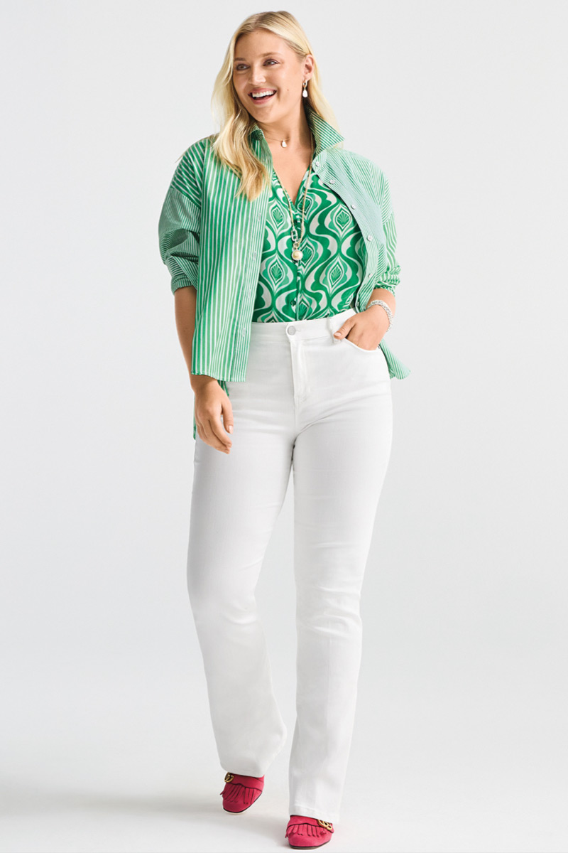 Model wearing Lagoon Necklace in Gold, Lagoon Earrings in Gold, Timepiece Necklace in Silver and Gold, 5th Ave Jean in White, Dad Shirt in Green Stripe, Scroll Top in Scroll Print