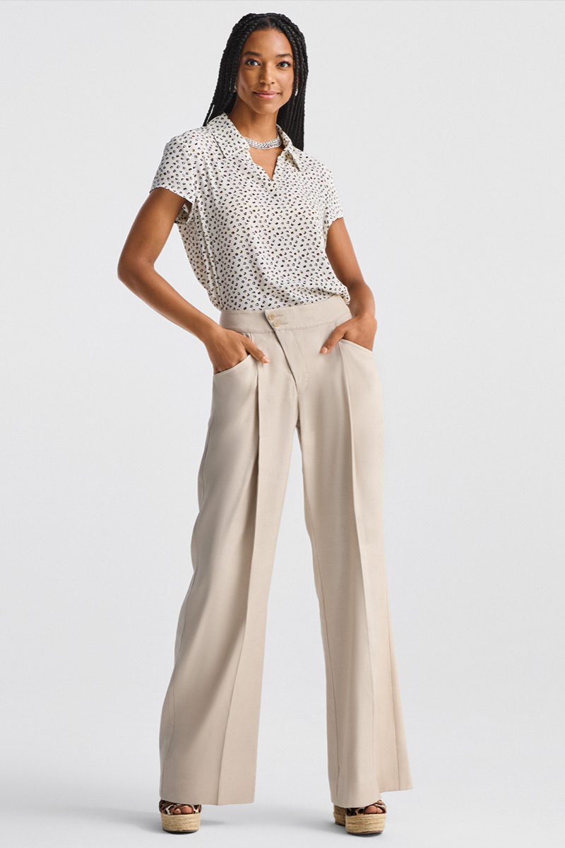 Model wearing Pebble Top in Baby Dot, Collar Hoop Earrings in Silver, Collar Necklace in Silver, Traipse Trouser in Biscotti