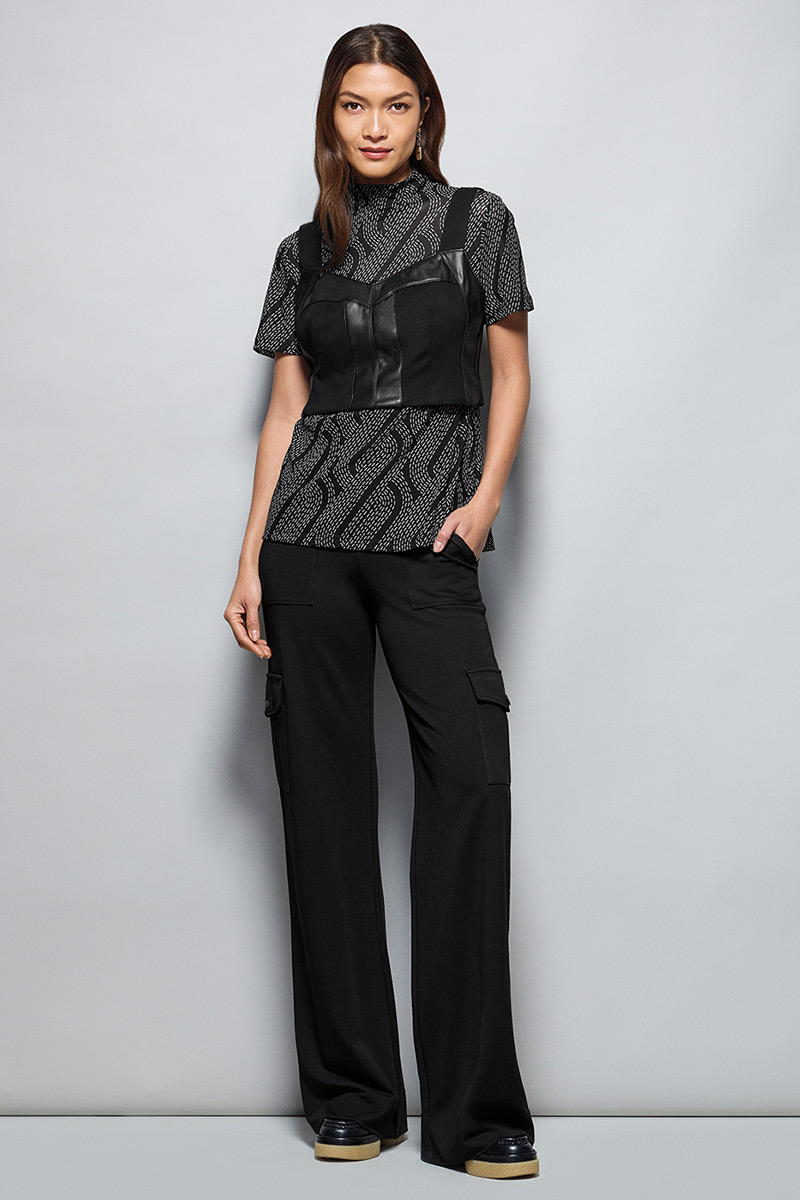 Model Wearing Deco Turtleneck in Black and White, Jett Bralette in Black, Chargo in Black, Fable Earrings in Gold.