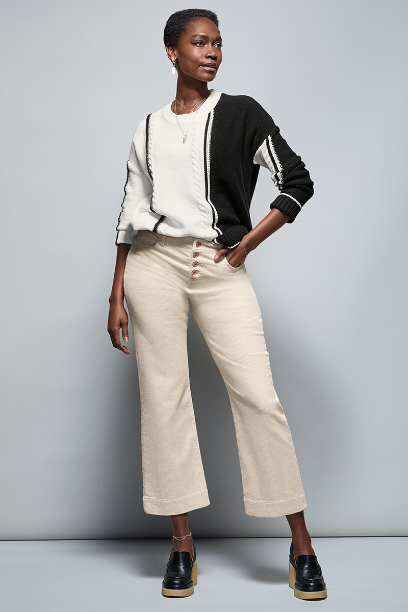 Model Wearing Lineup Pullover in Black and White, Palm Beach Crop in Bone, Fable Earrings in Gold, Fable Necklace in Gold.