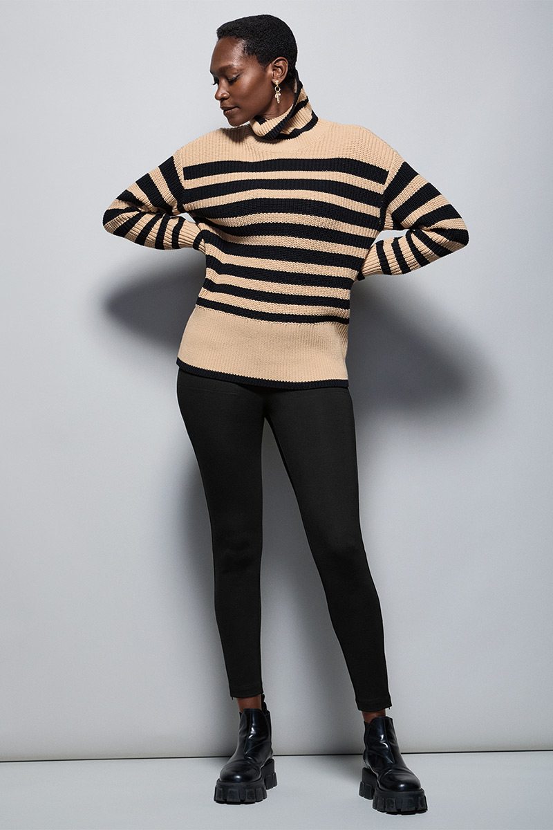 Model Wearing Polo Turtleneck in Black and Cream, Zip Legging in Black, Fable Earrings in Gold.