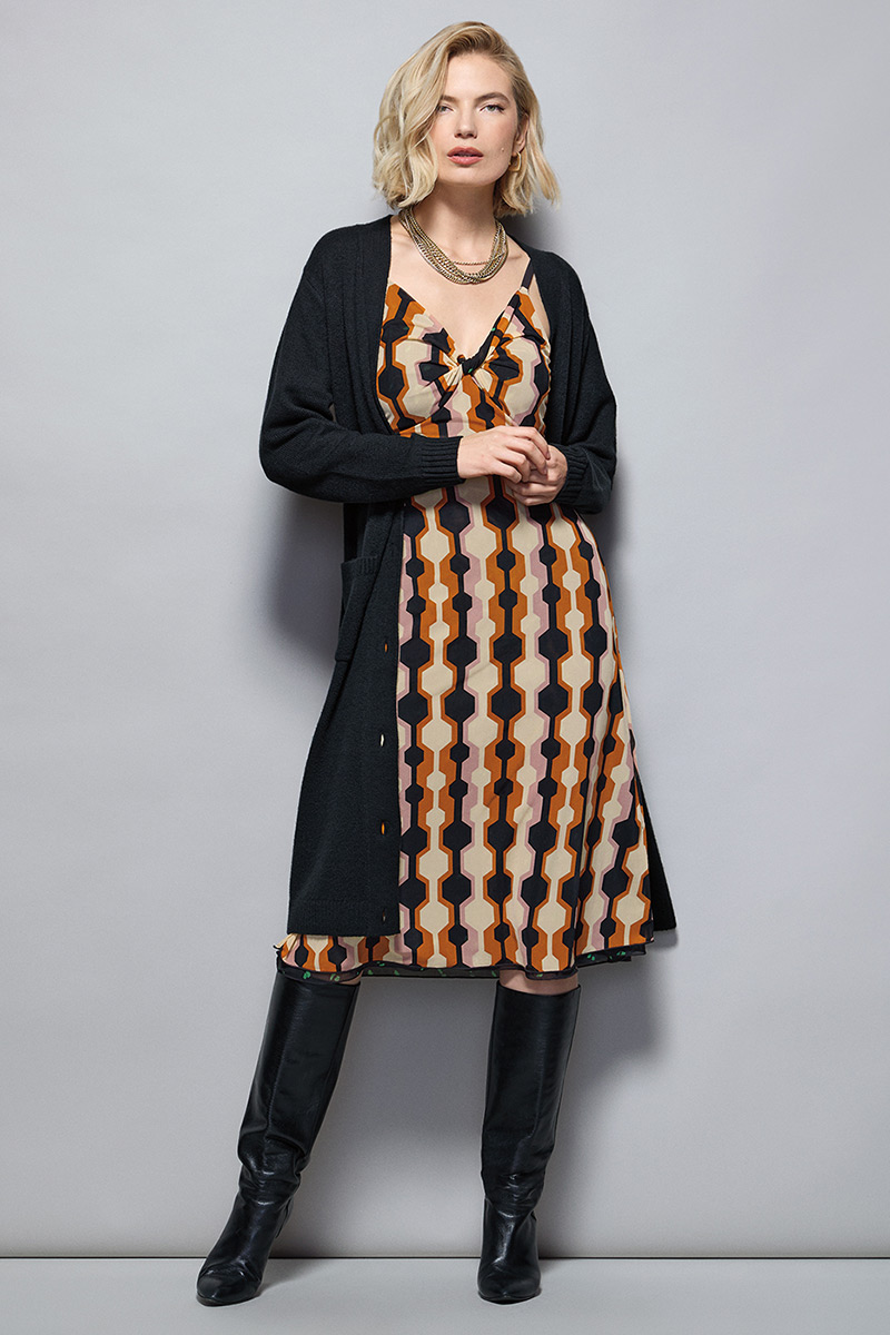 Model Wearing Drop-Off Cardigan in Black, Trophy Dress in Mixed Print, Fable Earrings in Gold, Fable Necklace in Gold.