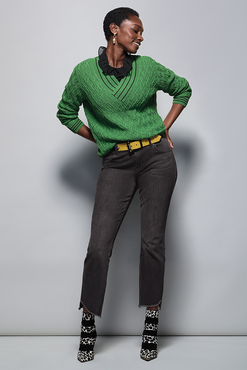 Model Wearing Lucky Day Pullover in Leaf, Cherish Blouse in Black, High-Low Crop in Washed Black, Dream Earrings in Gold, Ornament Belt in Black Combo.