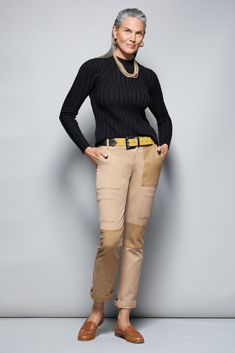 Model Wearing Contour Turtleneck in Black, Captain Pant in Khaki, Fable Earrings in Gold, Fable Necklace in Gold, Ornament Belt in Black Combo.