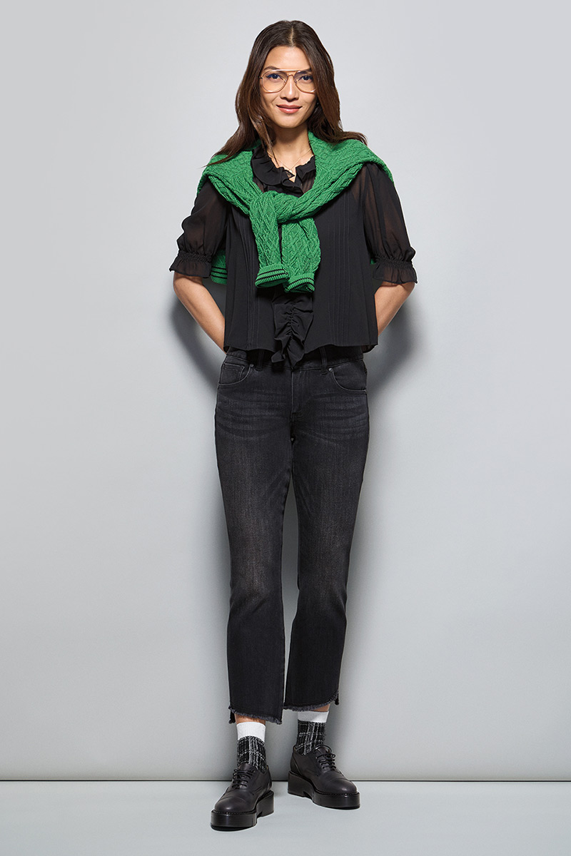 Model Wearing Lucky Day Pullover in Leaf, Cherish Blouse in Black, High-Low Crop in Washed Black, Fable Necklace in Gold.