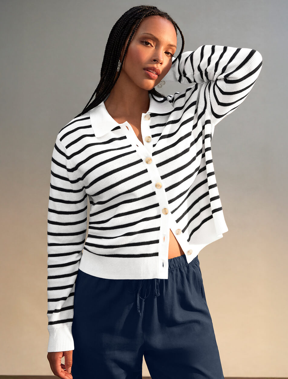 Female wearing a striped nautical top and dark navy blue bottoms